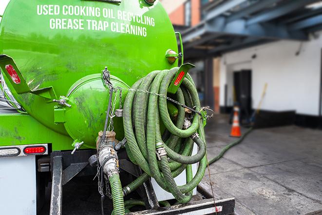 a technician pumping a grease trap in a commercial building in Post Falls